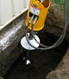 Installing a helical pier during a foundation repair in Fresno