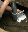 Fresno helical pier installation nearing completion, with the blade being advanced into the foundation soils.